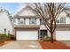 Two-story townhome with brick and siding exterior, two-car garage, and landscaping at 439 Mountain View Ln, Woodstock, GA 30188