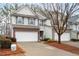 Two-story townhome with brick and siding exterior, two-car garage, and landscaping at 439 Mountain View Ln, Woodstock, GA 30188