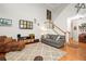 Living room with hardwood floors, gray sofa, and access to kitchen at 439 Mountain View Ln, Woodstock, GA 30188