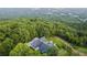 House nestled in trees with mountain views in background at 101 Barker Rd, Cumming, GA 30040