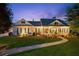 Beautiful home showcasing manicured landscaping, walkway, and charming front porch with decorative columns at twilight at 101 Barker Rd, Cumming, GA 30040