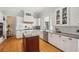 Modern kitchen with white cabinets, granite countertops, and large island at 101 Barker Rd, Cumming, GA 30040