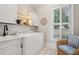 Bright laundry room with washer, dryer, and ample counter space at 101 Barker Rd, Cumming, GA 30040