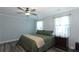 Spacious bedroom with a king-size bed and ceiling fan at 25 Water Oak Trl, Covington, GA 30014