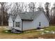 Side view of a gray house with a gray roof and wooden shutters at 25 Water Oak Trl, Covington, GA 30014