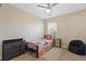 Small bedroom with twin bed, dresser, chair and window at 1246 Adcox Sq, Stone Mountain, GA 30088