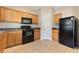 Modern kitchen with black appliances and light wood cabinets at 1246 Adcox Sq, Stone Mountain, GA 30088