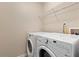 Laundry room with washer and dryer and overhead shelving at 1246 Adcox Sq, Stone Mountain, GA 30088