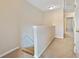 Upstairs hallway with carpeted floors and half wall at 1246 Adcox Sq, Stone Mountain, GA 30088