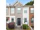 Brick townhouse exterior with a black metal front door and small landscaping at 2852 Vining Ridge Ter, Decatur, GA 30034