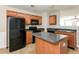 Kitchen with black appliances, wood cabinets, and an island at 2852 Vining Ridge Ter, Decatur, GA 30034