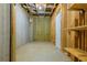 Unfinished basement showing insulated walls, concrete floor, and shelving at 342 Holbrook Rd, Smyrna, GA 30082