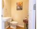 Small bathroom with white sink, toilet and a framed picture at 342 Holbrook Rd, Smyrna, GA 30082