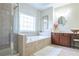 Bathroom featuring a tub and single vanity sink with wooden cabinets at 342 Holbrook Rd, Smyrna, GA 30082