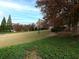 Landscaped green space with trees, a bench and walking path at 342 Holbrook Rd, Smyrna, GA 30082