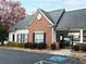 Community clubhouse featuring traditional brickwork, black shutters, and gated entrance at 342 Holbrook Rd, Smyrna, GA 30082