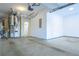 An empty garage with bare concrete floors, white walls, and a garage door opener at 342 Holbrook Rd, Smyrna, GA 30082