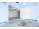 A large, empty garage with a bare concrete floor, white walls, and a door opener at 342 Holbrook Rd, Smyrna, GA 30082