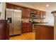 Modern kitchen with stainless steel appliances, wood cabinets, and hardwood floors at 342 Holbrook Rd, Smyrna, GA 30082