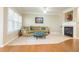 Bright living room with fireplace, plush sofa, ottoman and natural light at 342 Holbrook Rd, Smyrna, GA 30082