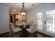 Bright dining area with glass table and access to back porch at 4620 Sammy Dr, Powder Springs, GA 30127