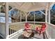 Cozy screened porch with firepit and red chairs at 4620 Sammy Dr, Powder Springs, GA 30127