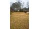 Overgrown lot with sparse grass and distant houses at 4751 Brownsville Rd, Powder Springs, GA 30127