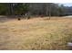 Empty lot with sparse grass and trees in the background at 4751 Brownsville Rd, Powder Springs, GA 30127