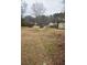 Large backyard with mature trees and a shed at 4751 Brownsville Rd, Powder Springs, GA 30127