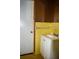 Small bathroom with yellow tiled walls and vanity at 4751 Brownsville Rd, Powder Springs, GA 30127