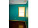 Bedroom with teal walls, wood floors, and window at 4751 Brownsville Rd, Powder Springs, GA 30127