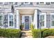 Gray front door with a wreath, stone steps, and landscaping at 100 Kendemere Pointe, Roswell, GA 30075