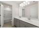 Bathroom with double vanity, mirror, and tub shower combo at 13553 Whitman Se Ln, Covington, GA 30014
