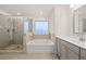 Bathroom with soaking tub, walk-in shower, and double vanity at 13553 Whitman Se Ln, Covington, GA 30014