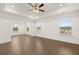 Spacious bedroom with hardwood floors and ceiling fan at 13553 Whitman Se Ln, Covington, GA 30014