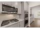 Modern kitchen with gray cabinets, granite countertops, and stainless steel appliances at 13553 Whitman Se Ln, Covington, GA 30014