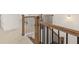 Elegant staircase with dark metal balusters and wooden handrail at 13553 Whitman Se Ln, Covington, GA 30014