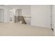Spacious upstairs hallway with neutral carpeting and a wooden staircase at 13553 Whitman Se Ln, Covington, GA 30014