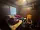 Small bedroom with basic furnishings and a window at 3453 Woodlawn Cir, Tucker, GA 30084