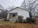 Quaint one-story home with a covered front porch and mature landscaping at 3453 Woodlawn Cir, Tucker, GA 30084