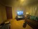 Simple living room with a sofa, TV, and basic decor at 3453 Woodlawn Cir, Tucker, GA 30084