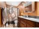 Clean bathroom with updated vanity and steampunk-themed shower curtain at 6308 Emerald Se Trl, Acworth, GA 30102