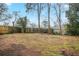 A spacious backyard featuring a fence, trees, and an expansive lawn at 1658 Hollyhock Ter, Decatur, GA 30032