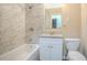 Bathroom featuring a shower-tub combo with marble tile surround and granite vanity top at 1658 Hollyhock Ter, Decatur, GA 30032