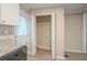 Kitchen featuring a granite countertop, stainless steel dishwasher, and walk-in pantry at 1658 Hollyhock Ter, Decatur, GA 30032