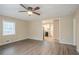 Open-concept living room with hardwood floors and view to kitchen at 1658 Hollyhock Ter, Decatur, GA 30032