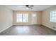 Inviting living room with wood-look flooring and plenty of natural light from large windows at 1658 Hollyhock Ter, Decatur, GA 30032