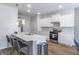 Modern kitchen with white cabinets, quartz countertops, and stainless steel appliances at 2797 Malton Way, Loganville, GA 30052