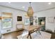 Farmhouse-style dining area with a rustic wooden table and wicker chandelier at 4290 Valley Trail Se Dr, Atlanta, GA 30339