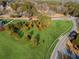 Aerial view capturing a green land with mature trees, situated at a road intersection with white fence at 5422 Hill Sw Rd, Powder Springs, GA 30127